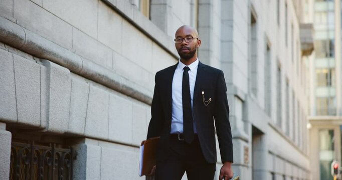 City, folder and walking with black man lawyer outdoor as legal council for court case or trial. Briefcase, buildings and travel with attorney at law downtown for commute to appointment as advocate