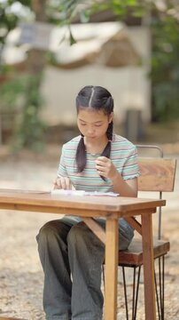 Asian girl making handmade necklace accessories