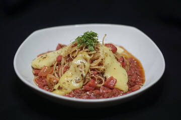 Delicious spaghetti dish. spaghetti cooking on black background