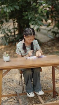 Asian girl making handmade necklace accessories