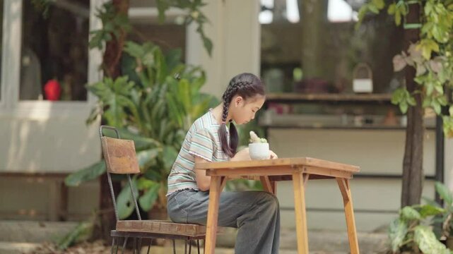 Asian girl making handmade necklace accessories