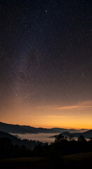 Fototapeta premium Night Sky Photo Showing Mountains And Stars With Golden And Dark Background