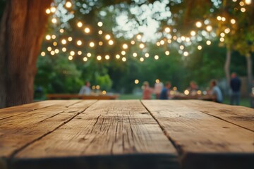 Rustic wooden table with blurred garden party background for product display and promotional content.