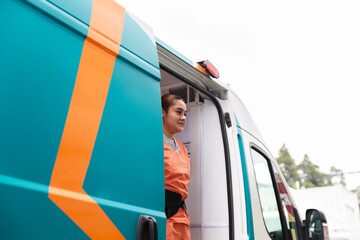 Nurse standing in an ambulance providing healthcare services