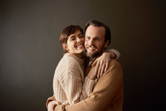 Couple embracing in a darker room showing love and togetherness