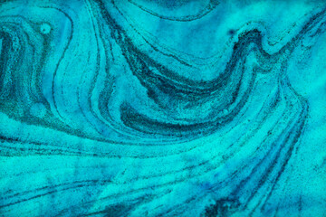 Blue ink patterns highlight artistic fluidity and depth