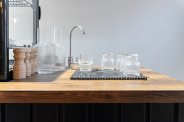 glasses and water carafes on a wooden countertop