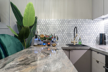stylish design of small kitchen in shades of gray. Cozy atmosphere in kitchen, dim lights. Grey...