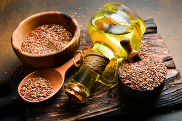 Flaxseed oil and flaxseed, close-up. On a dark background. Top view.