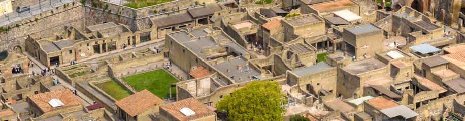 Fototapeta premium Aerial view of the remains and excavations of Herculaneum. It is an archaeological area of ​​an ancient Roman city, near Pompeii, in the province of Naples, Italy. It is a tourist destination.