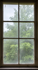 Photo of Old Wooden Window with Raindrops and Green Tree in Background