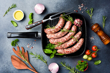 Grill pan and homemade beef sausages ready to cook. Top view.