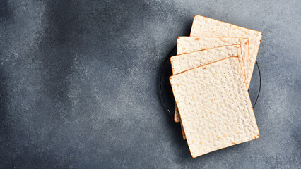 Jewish matzah bread. On a gray concrete background. Top view.