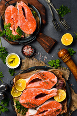 Raw fresh salmon steaks with spices and lemon. Top view.