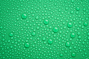 Water drops on an abstract green background. Macro photo. Top view.