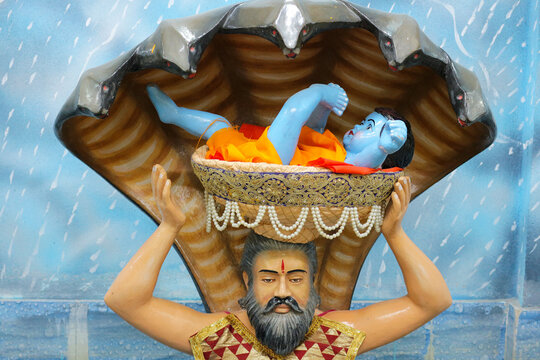 Father Vasudeva carries Krishna across the waters of the Yamuna. Installation in Beyt Dwarka, Gujarat, India on November 23, 2024