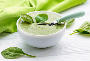Spinach cream soup closeup top view.Organic mashed vegan meal.