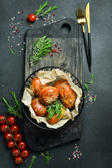 Freshly baked buns with sesame in a basket. On a black stone background. Bread.