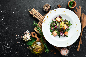 Fresh salad with salmon and quinoa. Healthy food. On a white plate. Rustic style.