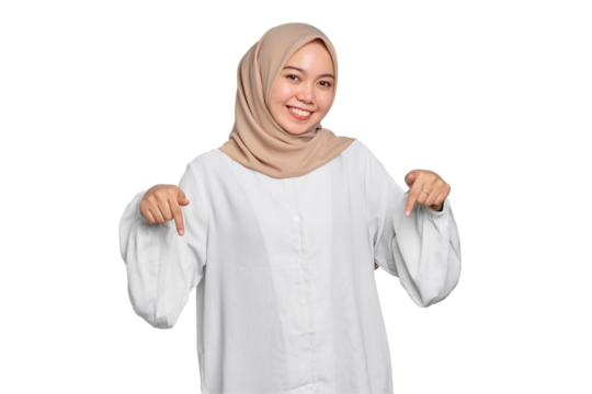 Portrait of Asian Muslim woman smiling pointing fingers down, inviting customers to special event isolated on transparent background