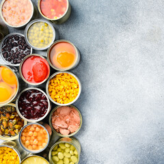 Set of canned preserves food in tin open cans. Food stocks. Side view.