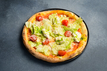 Pizza Caesar. Pizza with chicken, cheese and lettuce. Top view. Free space for your text.