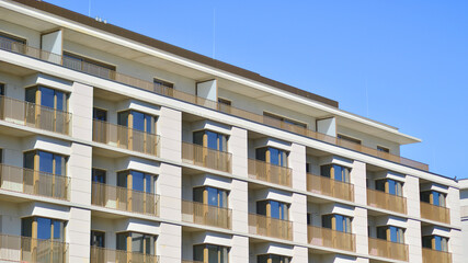 Fototapeta premium Modern new residential apartment house building complex. Exterior view of modern apartment building. New construction apartment or condo complex.