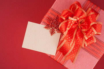 Red gift box with a blank card and ribbon