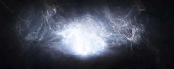 Abstract smoke texture over black background. Fog in the darkness.