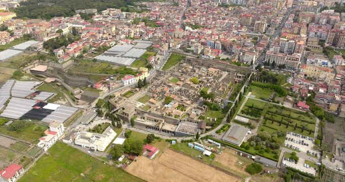 Aerial view of the archaeological area of ​​the excavations of Herculaneum. It was an ancient Roman city. In the background the modern city of Ercolano, in the province of Naples, Italy.