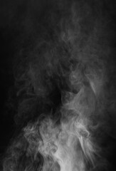 Abstract smoke texture over black background. Fog in the darkness.