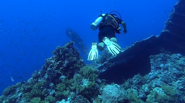 Diver approaching a deep wreck - Egypt Red Sea - BDE