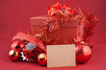 Red Christmas gift box with ornaments and blank card
