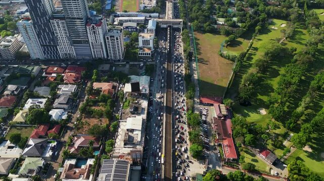 Overhead drone shot of bustling EDSA (Epifanio de los Santos Avenue) highway during rush hour along Santolan Annapolis, San Juan City, Philippines