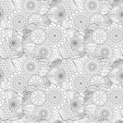 Black and white ethnic seamless pattern with floral and abstract patterns. Natural motifs and rounded ornaments depicting flowers.