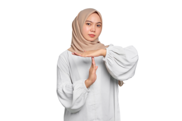 Serious young Asian Muslim woman showing time out gesture with hands isolated on transparent background