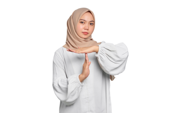 Serious young Asian Muslim woman showing time out gesture with hands isolated on transparent background