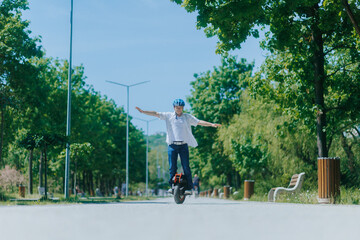 Happy Man Riding Electric Monowheel With Hands in the Air © Alexandr