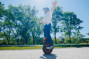 Stylish Man Enjoys Electric Monowheel Ride in Tree-Lined Park © Alexandr