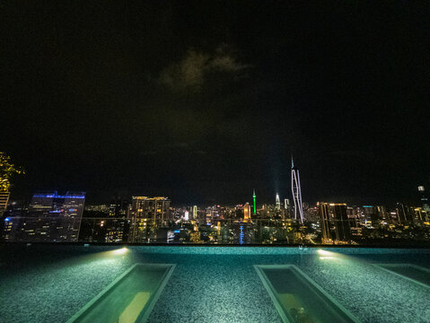 Fototapeta Infinity pool edge overlooking skyline at night, Kuala Lumpur, Malaysia