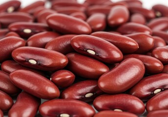 Close-up of a pile of kidney beans showing their smooth, dark red skin and white hilum in a food background