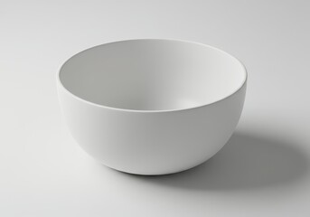 A simple white bowl sits on a white surface in a minimalist, clean composition