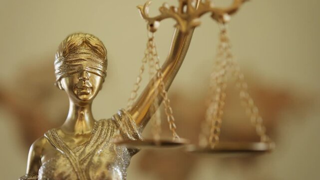 Statue of justice goddess Themis with blindfold and scales
