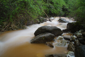 flowing water in a creek over the mountains in tuscany