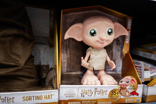 Dobby figurine displayed in wizarding world themed packaging in store