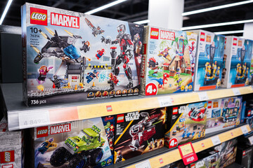 Naklejka premium Lego sets on store shelves featuring Marvel, Star Wars, and more themes