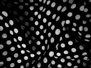 Black fabric with white polka dots pattern	