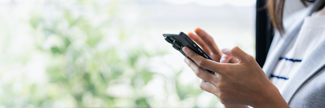 Woman use smart phone at workplace for online web internet search .