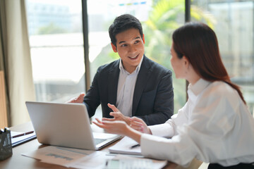 Asian office employee supervising Mentor training trainee at office