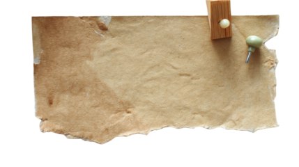 A piece of rustic brown paper rests on a white background, held in place by a wooden clip and a pin. The blank surface invites notes or creative ideas, offering a versatile canvas for messages